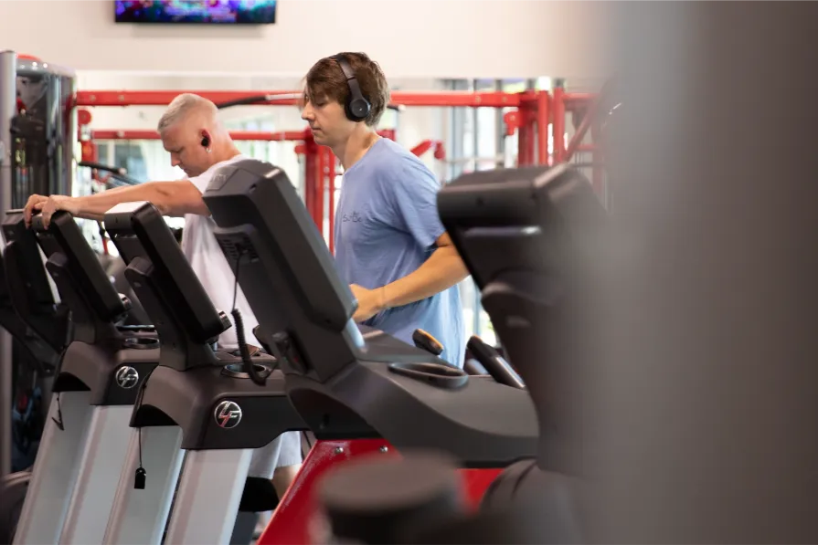 Two men working out on a treadmill