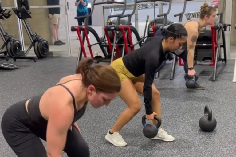 3 women working out with kettle bells.