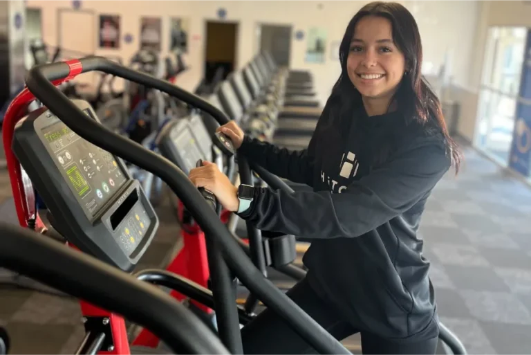 a girl smiling while working out.