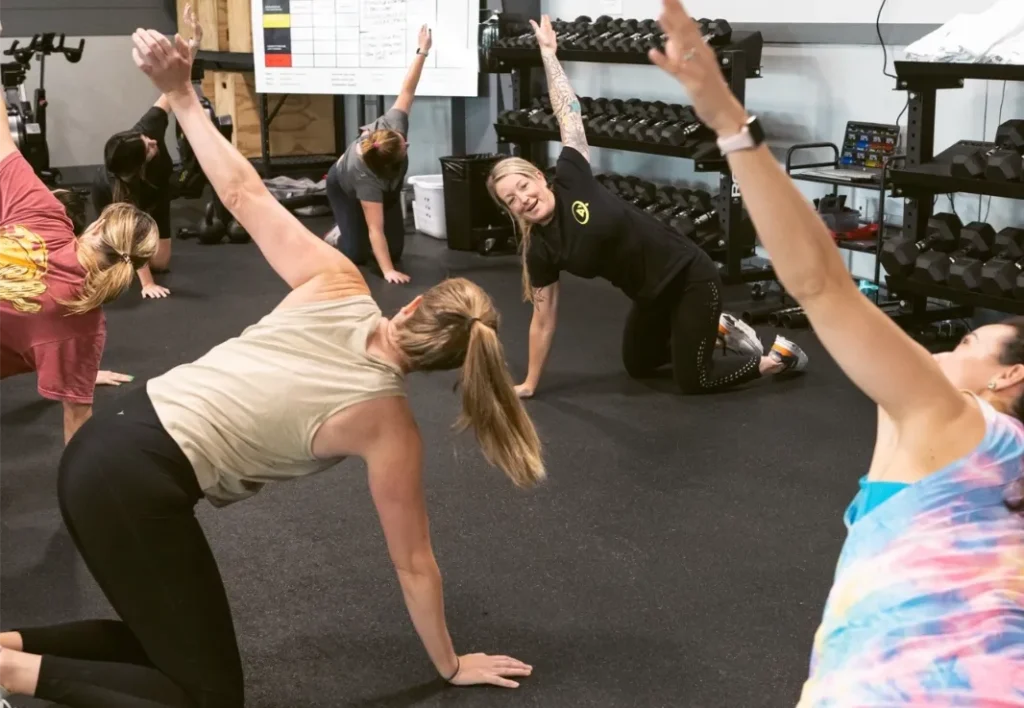 A group of women stretching before a workout.