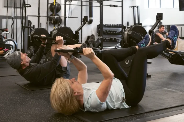 2 people working out with plates.