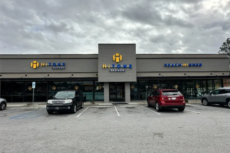 Parking lot and entrance of a Hi Tone Fitness entrance.