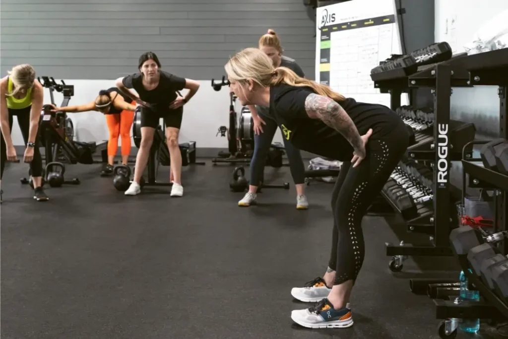 4 Women stretching in a gym.