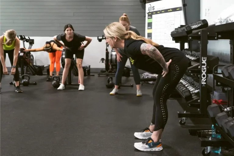 4 Women stretching in a gym.