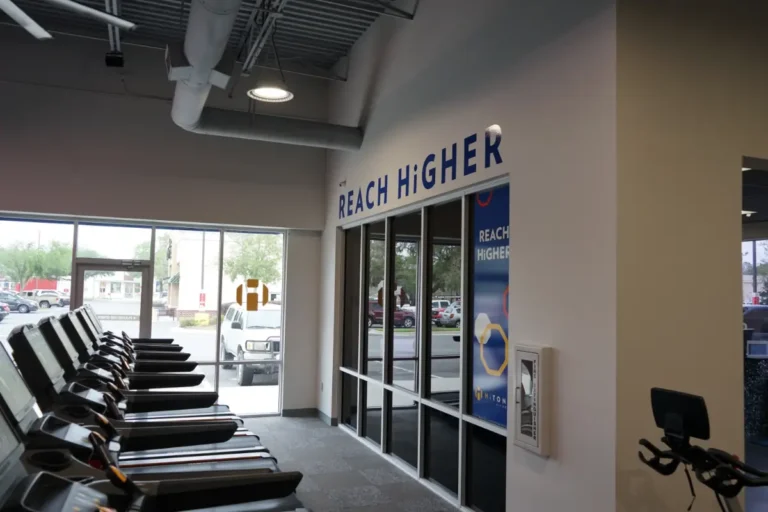 Treadmills, next to a reach higher sign.