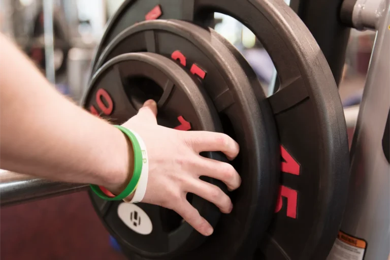 Person setting up weights.