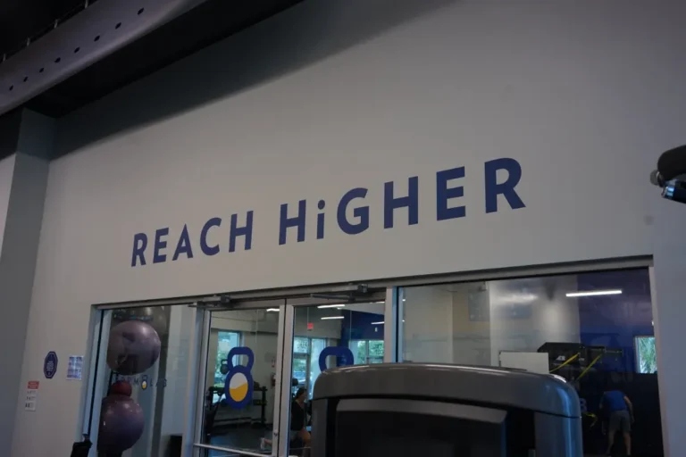 A sign which says reach higher.