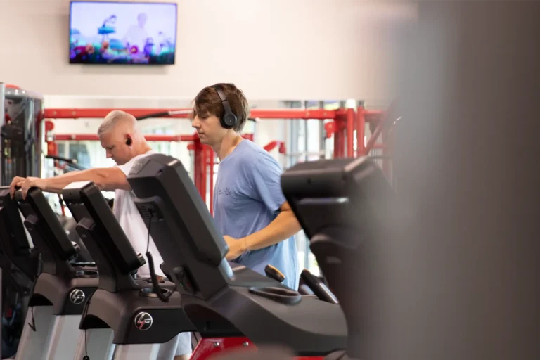 Two men on treadmill.