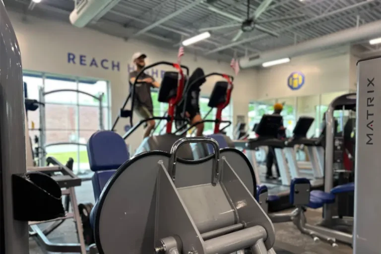 A shot of cardio machines and people using them.