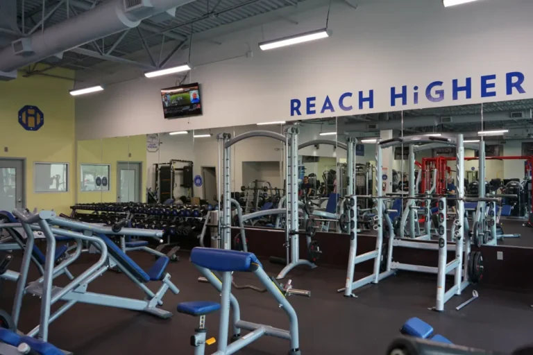 A gym with a reach higher sign.