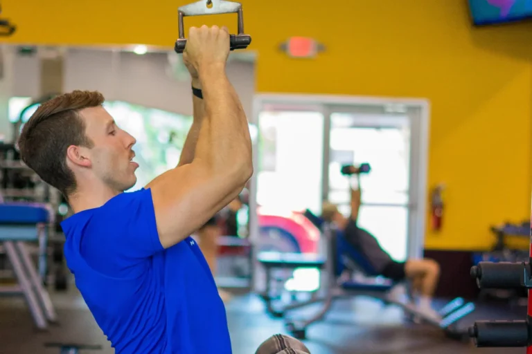 Man in blue shirt working out.