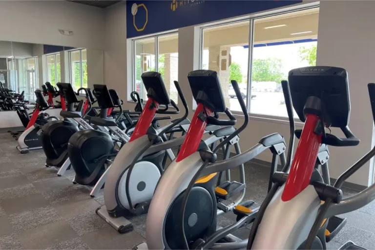 Elliptical trainer machines at a fitness center.