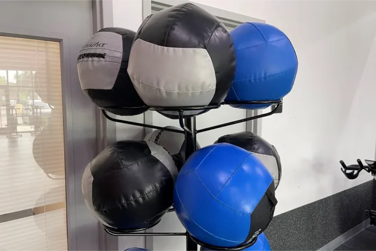 Seven medicine balls on a rack.