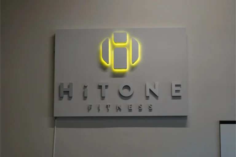 A HiTONE fitness wall sign.