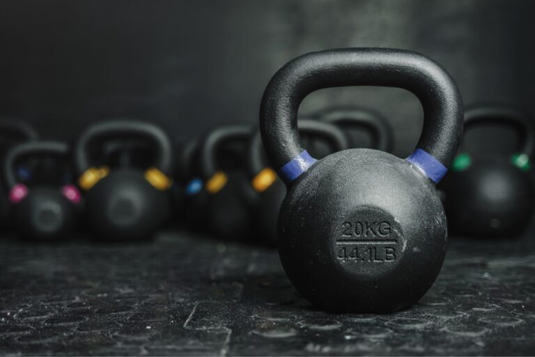 44.1LB kettlebell in front of blurred exercise tools.