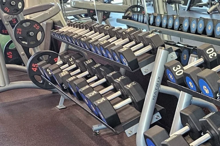 A dumbbell rack with blue yellow symbols.