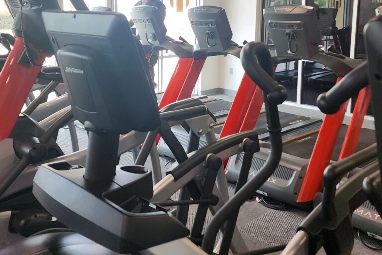 Treadmills and other cardio equipment inside of a fitness center.